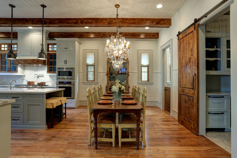 Design ideas for a traditional open plan dining in Houston with beige walls, medium hardwood floors and brown floor.
