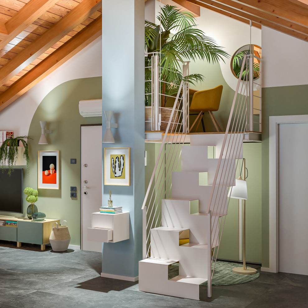 This is an example of a large contemporary loft-style living room in Milan with a library, multi-coloured walls, porcelain floors, a wall-mounted tv, grey floor and exposed beam.