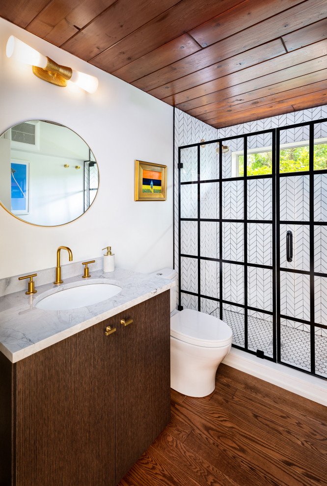 Photo of a midcentury bathroom in Boston with flat-panel cabinets, brown cabinets, white tile, white walls, dark hardwood floors, an undermount sink, quartzite benchtops, a hinged shower door, white benchtops, a single vanity, a built-in vanity and wood.