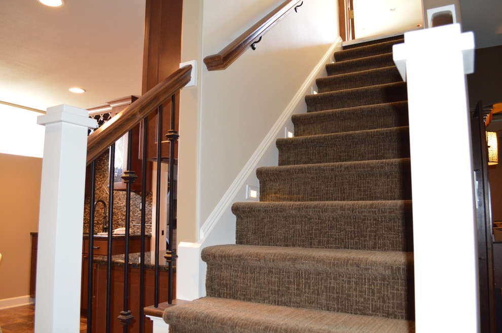 Photo of a large transitional carpeted straight staircase in Milwaukee with carpet risers.