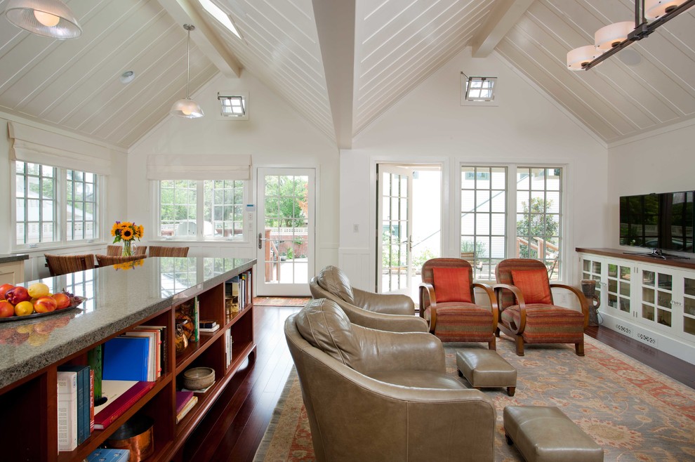 Photo of a traditional living room in San Diego with white walls, dark hardwood floors and a freestanding tv.
