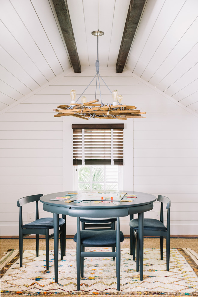 Photo of a beach style dining room in Charleston with white walls.