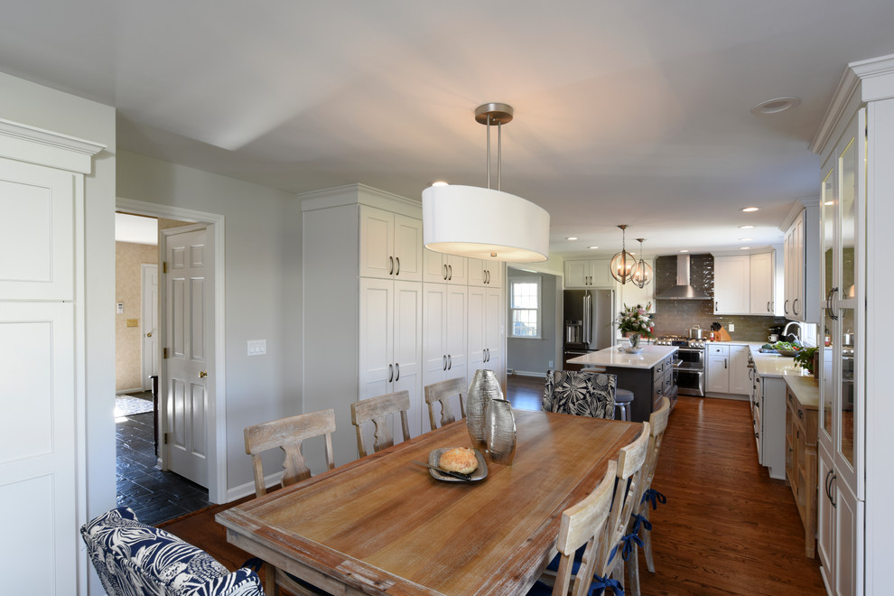 Eat-in kitchen - transitional l-shaped medium tone wood floor eat-in kitchen idea in Orange County with a double-bowl sink, shaker cabinets, white cabinets, marble countertops, gray backsplash, glass tile backsplash, stainless steel appliances and an island