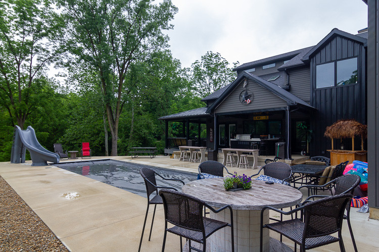 Inspiration for a mid-sized country backyard concrete and rectangular lap water slide remodel