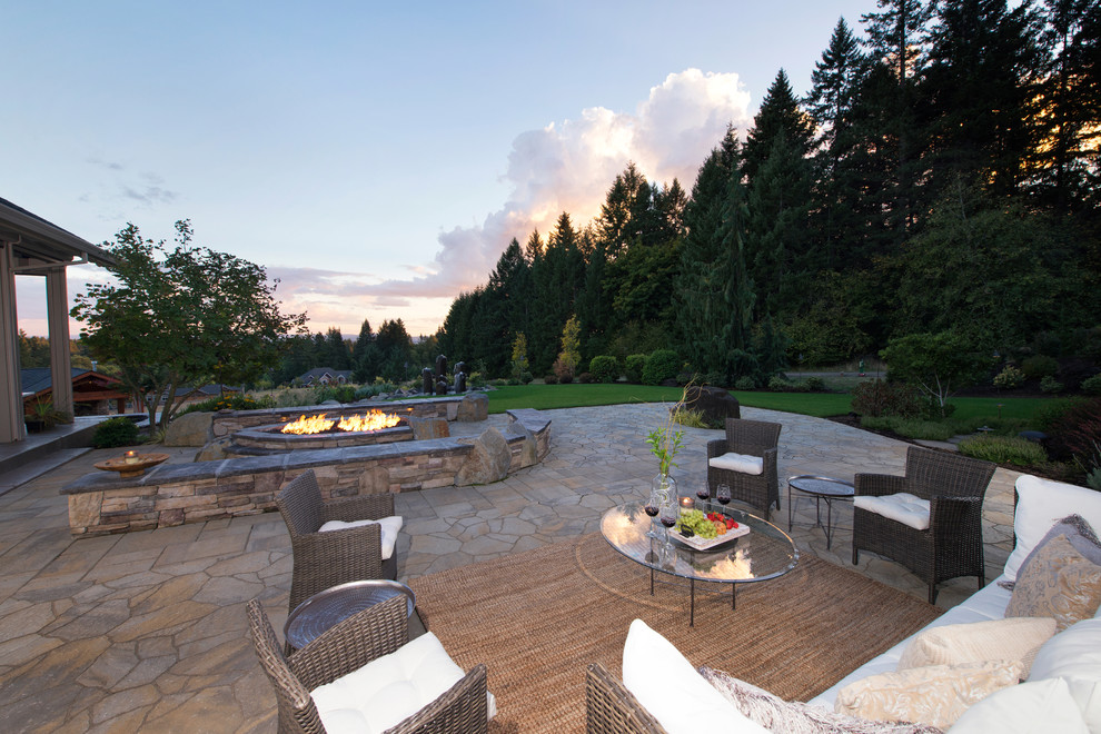 Large traditional backyard full sun garden in Portland with concrete pavers for spring.