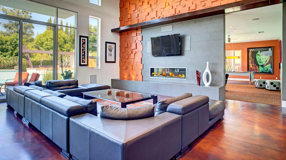 This is an example of a contemporary open concept living room in Orange County with a ribbon fireplace and a wall-mounted tv.