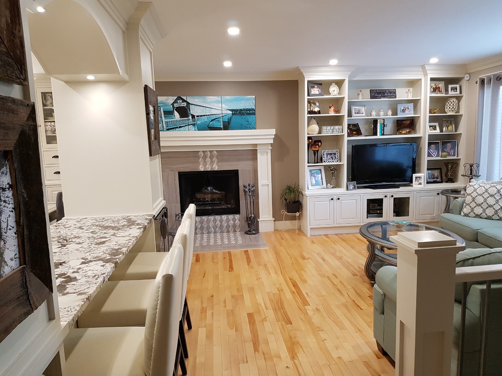Inspiration for a mid-sized transitional formal and open concept light wood floor and brown floor living room remodel in Calgary with gray walls, a standard fireplace, a tile fireplace and a tv stand