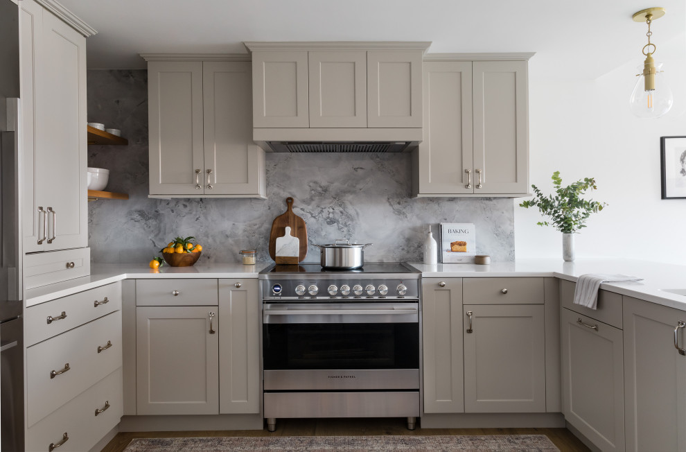 Example of a transitional eat-in kitchen design in Boston with recessed-panel cabinets, beige cabinets, quartz countertops, gray backsplash, stone slab backsplash, stainless steel appliances, a peninsula, white countertops and an undermount sink