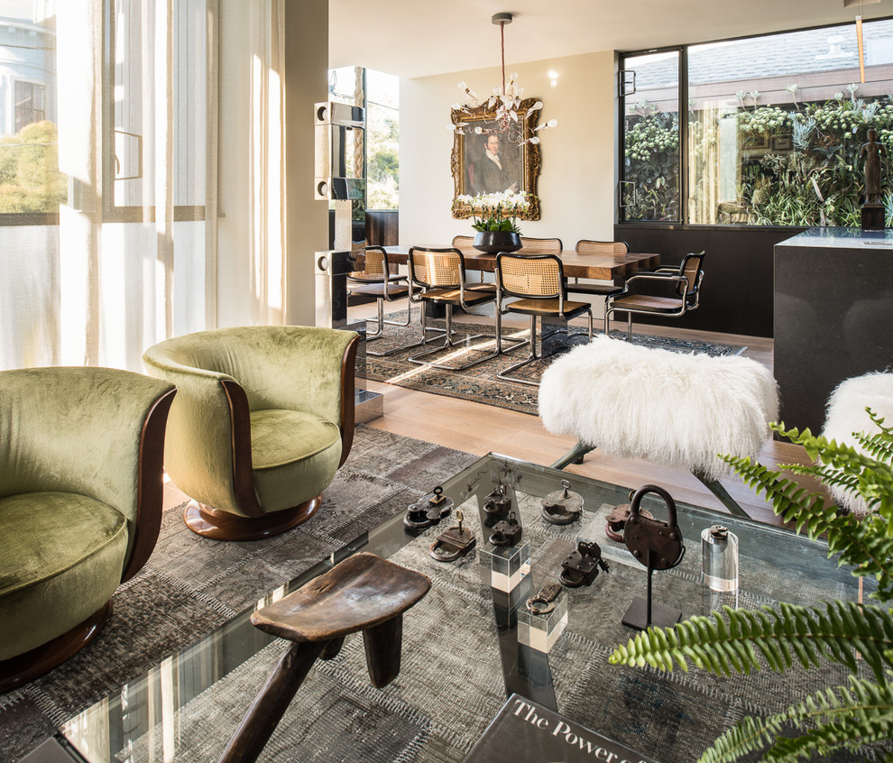 Example of a mid-sized eclectic open concept light wood floor living room design in San Francisco with white walls and no fireplace