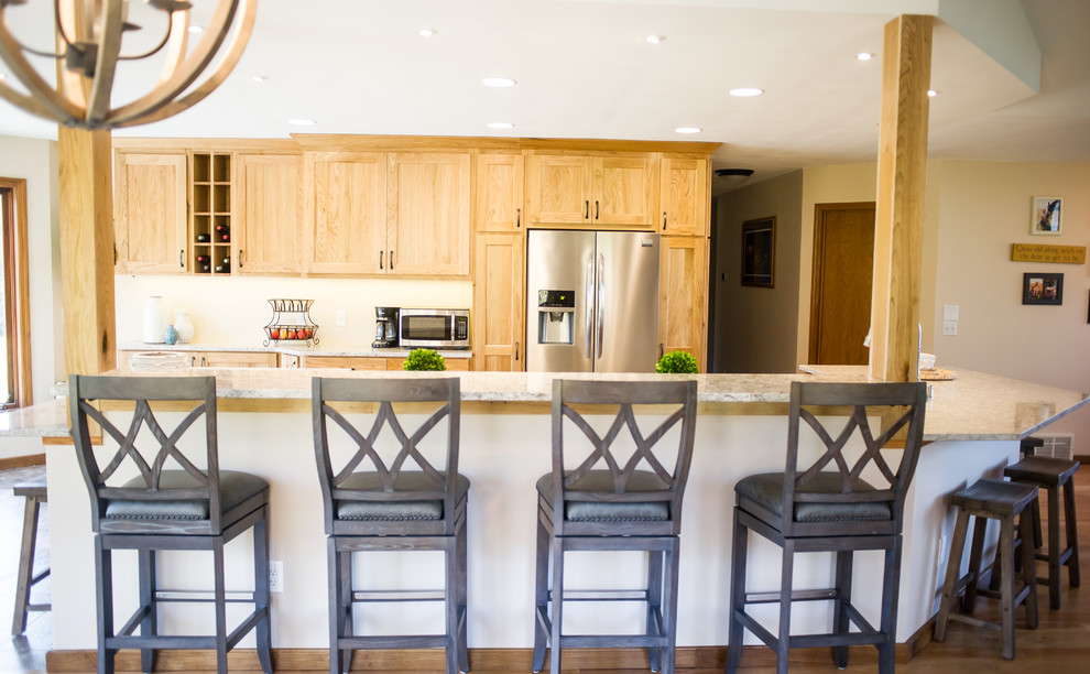 Example of a large mountain style u-shaped medium tone wood floor open concept kitchen design with an undermount sink, recessed-panel cabinets, purple cabinets, beige backsplash, stainless steel appliances, an island and granite countertops