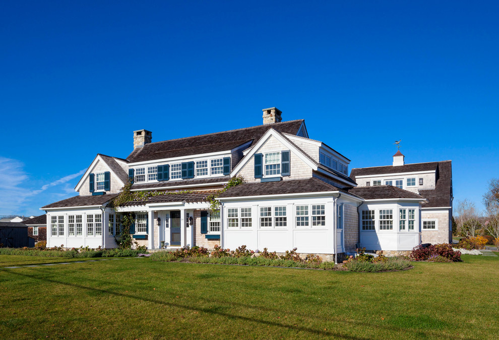 This is an example of a large beach style two-storey exterior in Providence with wood siding.