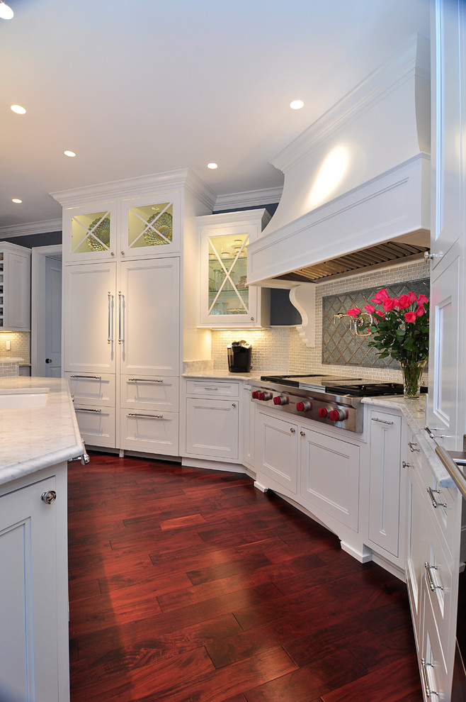 Photo of a traditional eat-in kitchen in Other with flat-panel cabinets, white cabinets, marble benchtops, multi-coloured splashback, glass tile splashback and panelled appliances.