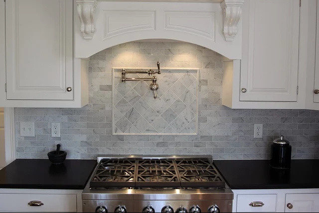 Enclosed kitchen - mid-sized transitional single-wall enclosed kitchen idea in New York with beaded inset cabinets, white cabinets, soapstone countertops, gray backsplash, stone tile backsplash and stainless steel appliances