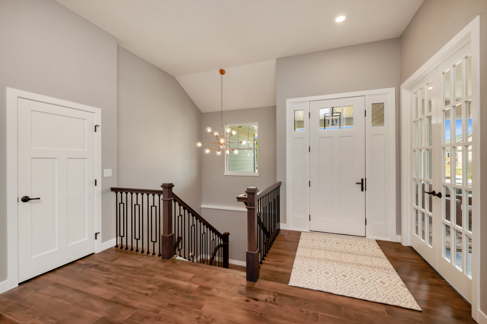 Inspiration for a transitional medium tone wood floor and brown floor entryway remodel in Cedar Rapids with gray walls