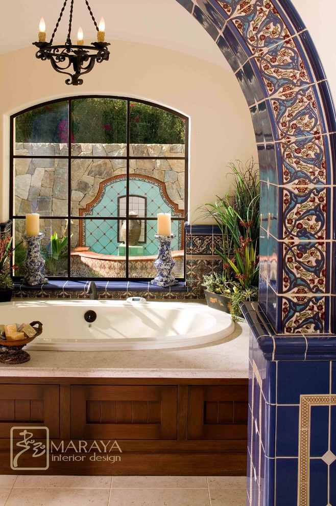 Inspiration for a huge mediterranean master blue tile and ceramic tile limestone floor bathroom remodel in Santa Barbara with an undermount sink, furniture-like cabinets, distressed cabinets, limestone countertops, a two-piece toilet and white walls