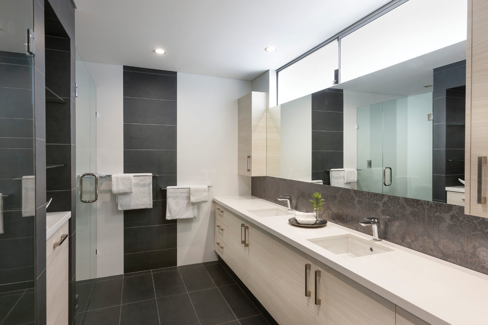 Inspiration for a mid-sized contemporary master bathroom in Perth with flat-panel cabinets, white cabinets, an alcove shower, a two-piece toilet, black tile, ceramic tile, white walls, concrete floors, a drop-in sink, engineered quartz benchtops, white floor, a hinged shower door and white benchtops.