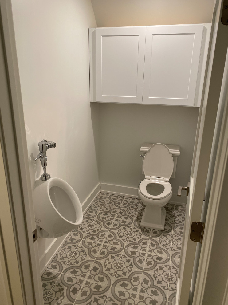 Photo of a large transitional master bathroom in Nashville with recessed-panel cabinets, white cabinets, a claw-foot tub, a double shower, an urinal, white walls, porcelain floors, an undermount sink, marble benchtops, a hinged shower door, grey benchtops, an enclosed toilet, a double vanity, a freestanding vanity and vaulted.