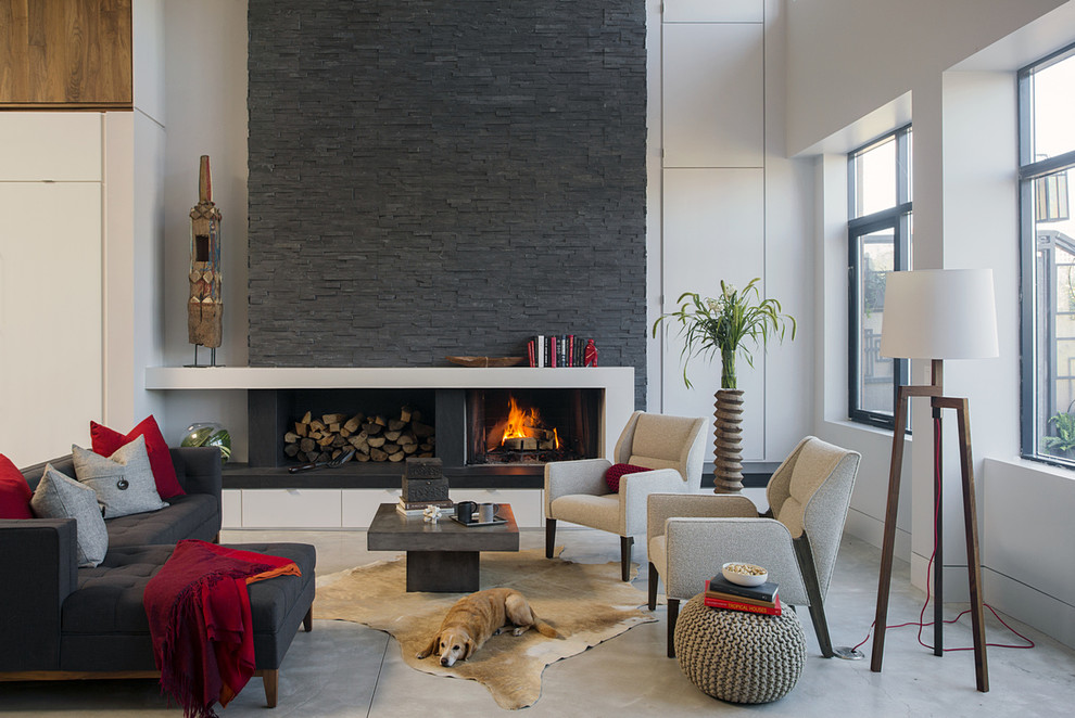 This is an example of a mid-sized contemporary formal open concept living room in Boston with white walls, concrete floors, a standard fireplace and a stone fireplace surround.