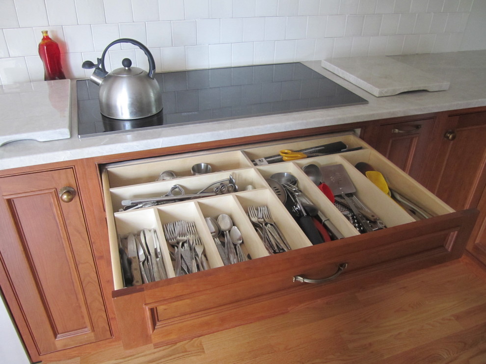 Example of a large transitional l-shaped light wood floor open concept kitchen design with a single-bowl sink, beaded inset cabinets, medium tone wood cabinets, quartzite countertops, white backsplash, ceramic backsplash, stainless steel appliances and no island