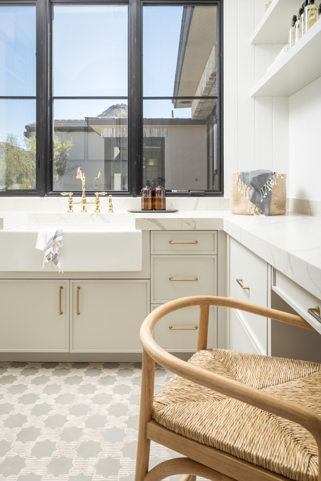 Inspiration for a large classic u-shaped utility room in Phoenix with a belfast sink, beaded cabinets, grey cabinets, engineered stone countertops, white splashback, marble splashback, white walls, marble flooring, a stacked washer and dryer, grey floors, white worktops, a coffered ceiling and wallpapered walls.