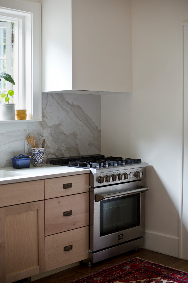 Inspiration for a small transitional l-shaped medium tone wood floor kitchen remodel with an undermount sink, shaker cabinets, multicolored backsplash, marble backsplash, stainless steel appliances and no island