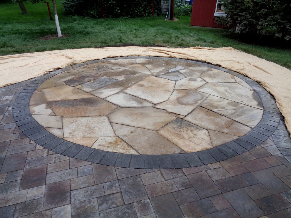 Inspiration for a mid-sized contemporary backyard patio in Minneapolis with concrete pavers.