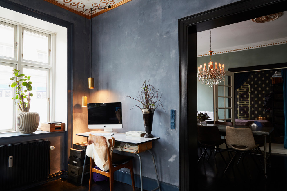 Photo of an eclectic home office in Copenhagen with black walls.