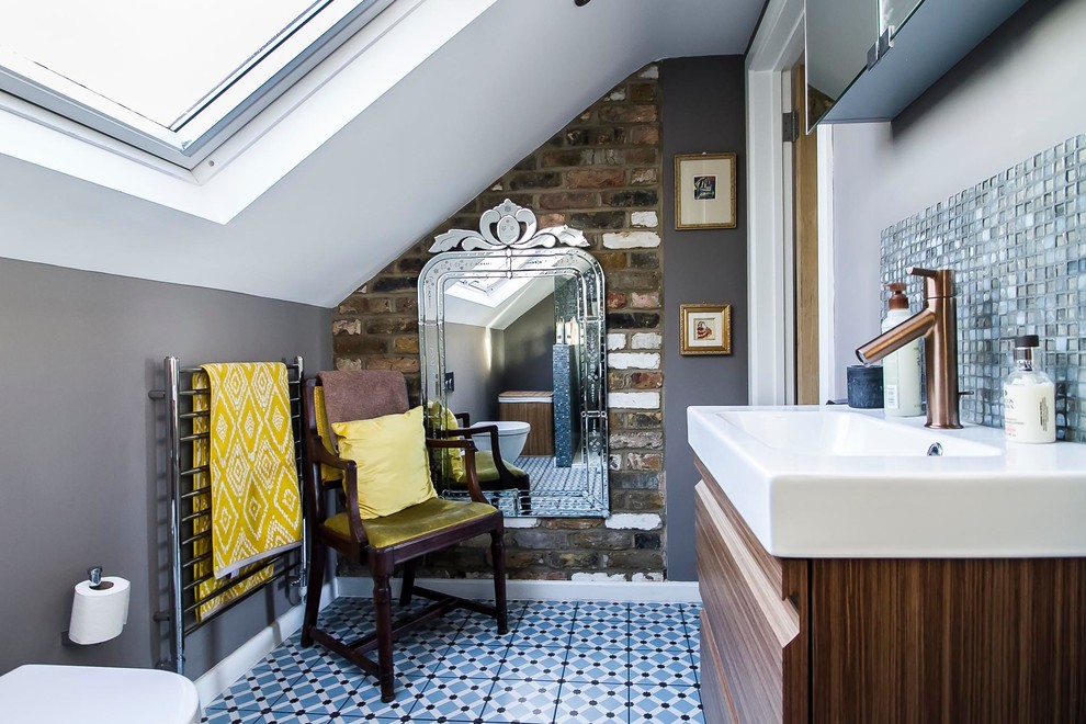 Inspiration for a small eclectic master bathroom in London with flat-panel cabinets, brown cabinets, an open shower, gray tile, mosaic tile, grey walls, porcelain floors, blue floor, an open shower, a wall-mount toilet and a console sink.