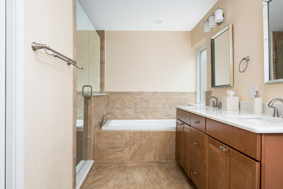 Design ideas for a mid-sized contemporary master bathroom in Dallas with shaker cabinets, brown cabinets, an alcove tub, an alcove shower, a one-piece toilet, white tile, blue walls, porcelain floors, an undermount sink, marble benchtops, beige floor and a hinged shower door.