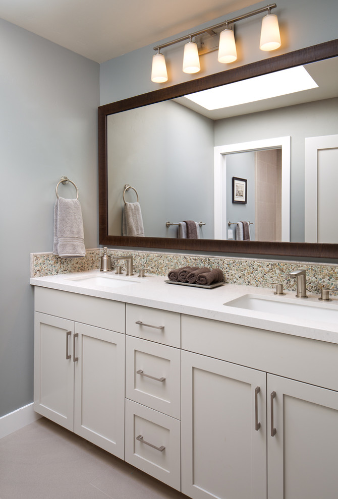 Design ideas for a mid-sized contemporary bathroom in San Diego with an undermount sink, shaker cabinets, grey cabinets, engineered quartz benchtops, an alcove tub, an alcove shower, a one-piece toilet, multi-coloured tile, mosaic tile, blue walls and porcelain floors.