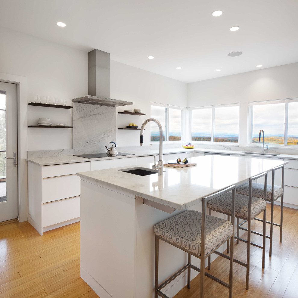 Design ideas for a contemporary kitchen in Burlington with flat-panel cabinets, white cabinets, quartzite benchtops, white splashback, with island and white benchtop.