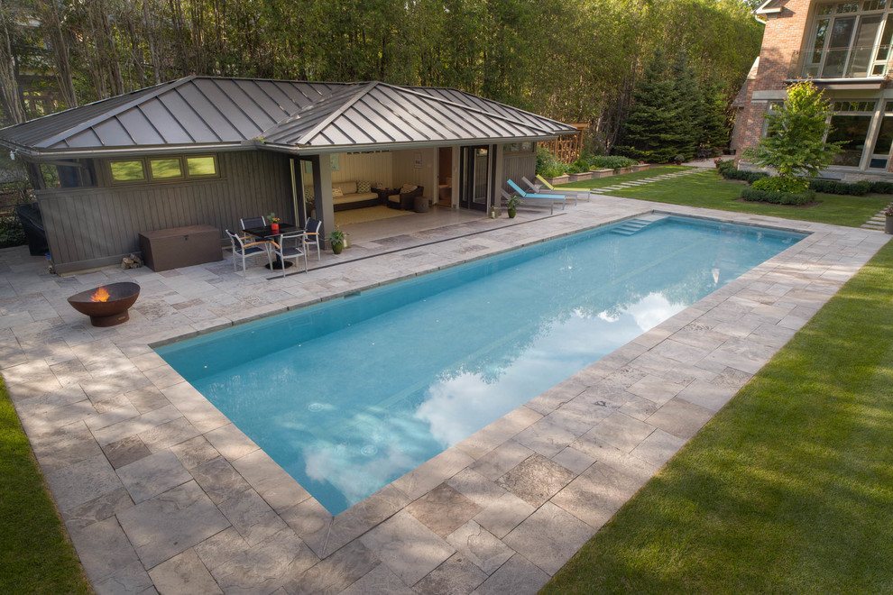 Inspiration for a large transitional backyard stone and rectangular pool house remodel