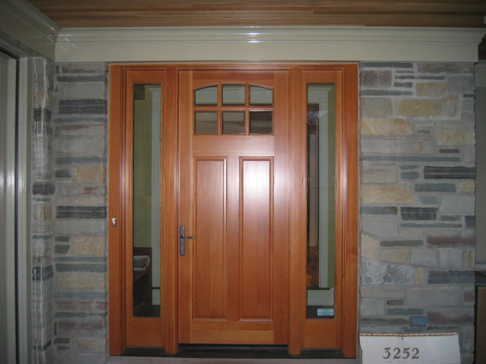 Inspiration for a mid-sized traditional front door in Toronto with grey walls, slate floors, a single front door and a light wood front door.