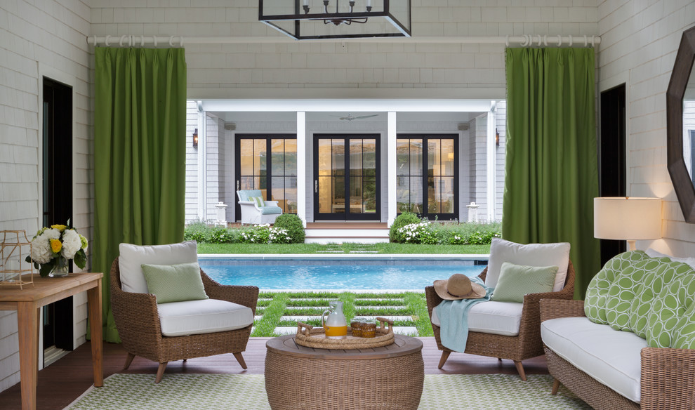 Photo of a mid-sized traditional backyard rectangular pool in New York with a pool house and concrete pavers.