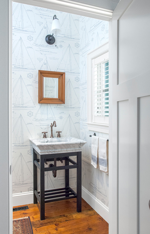 Beach style powder room in Portland Maine with an integrated sink, multi-coloured walls, medium hardwood floors and open cabinets.