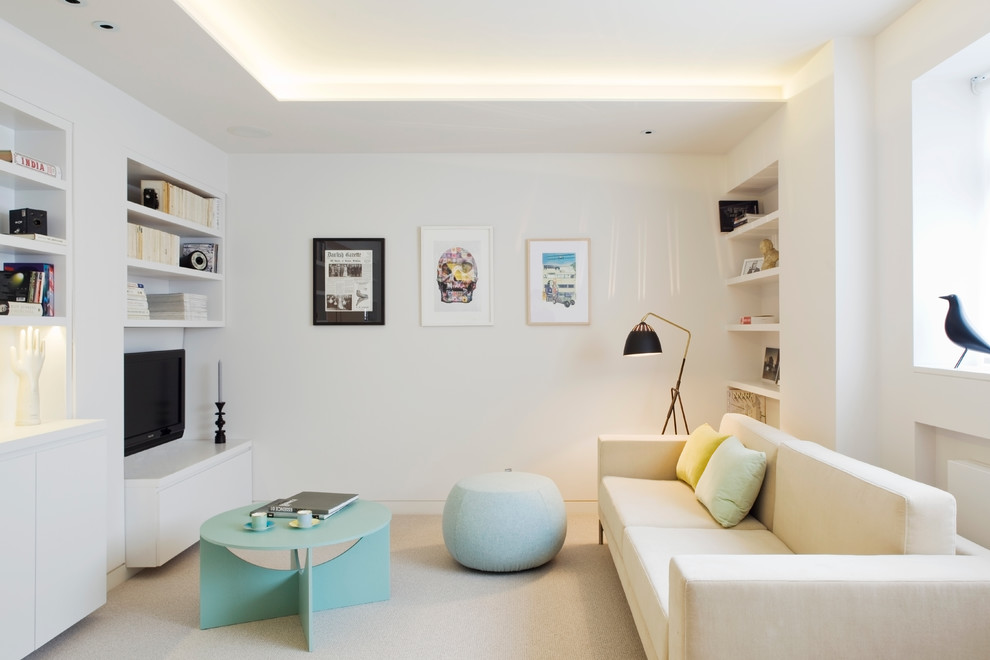 Contemporary family room in London with white walls, carpet, no fireplace and a wall-mounted tv.