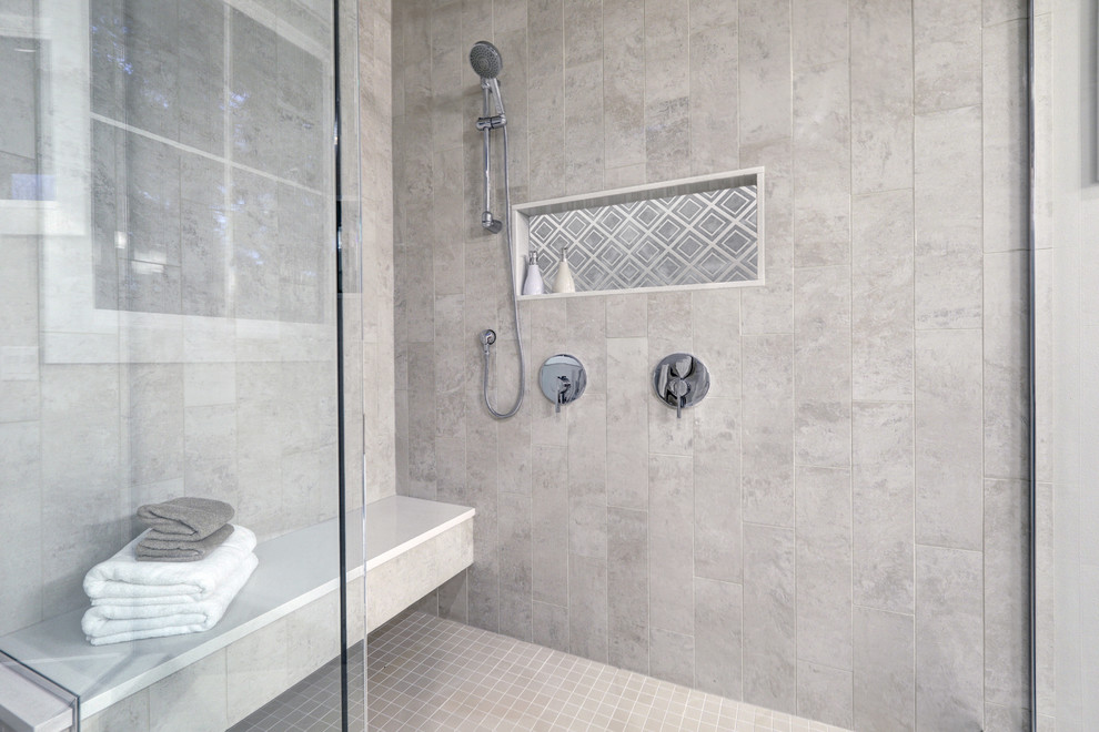 Photo of a large modern master bathroom in New York with an open shower, gray tile and stone tile.