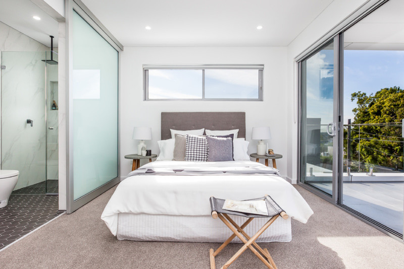 Mid-sized transitional master bedroom in Sydney with white walls and carpet.