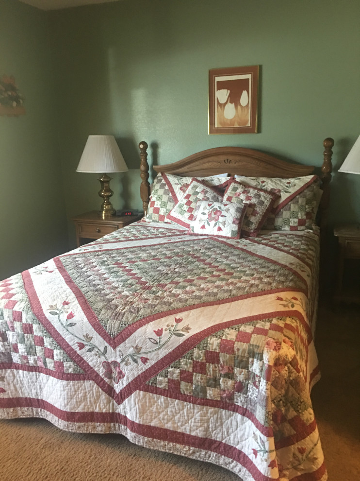 Mid-sized mountain style master beige floor bedroom photo with green walls