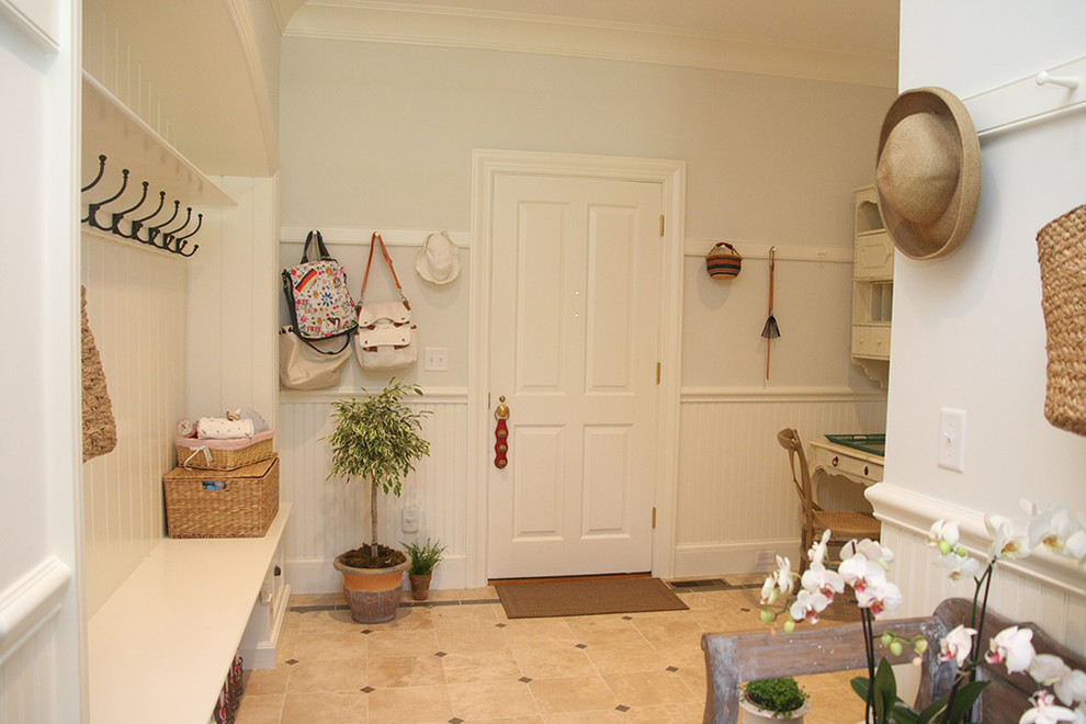 Inspiration for a mid-sized traditional mudroom in Other with white walls, a single front door, a white front door and beige floor.