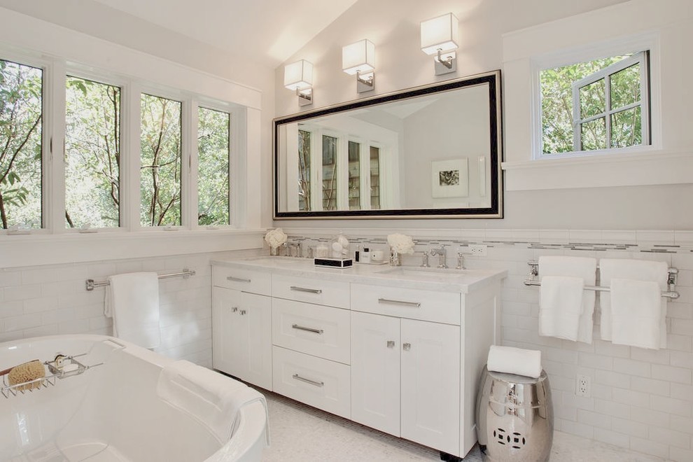 Inspiration for a transitional bathroom in San Francisco with a freestanding tub, an undermount sink, white cabinets, marble benchtops, white tile, subway tile and shaker cabinets.