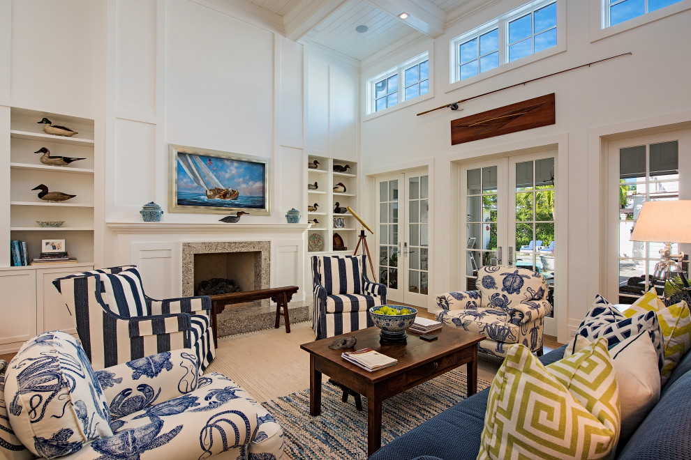 Inspiration for a beach style formal open plan living room in Miami with white walls, medium hardwood flooring, a standard fireplace, a stone fireplace surround, no tv, brown floors, a coffered ceiling, a timber clad ceiling, a wood ceiling and panelled walls.