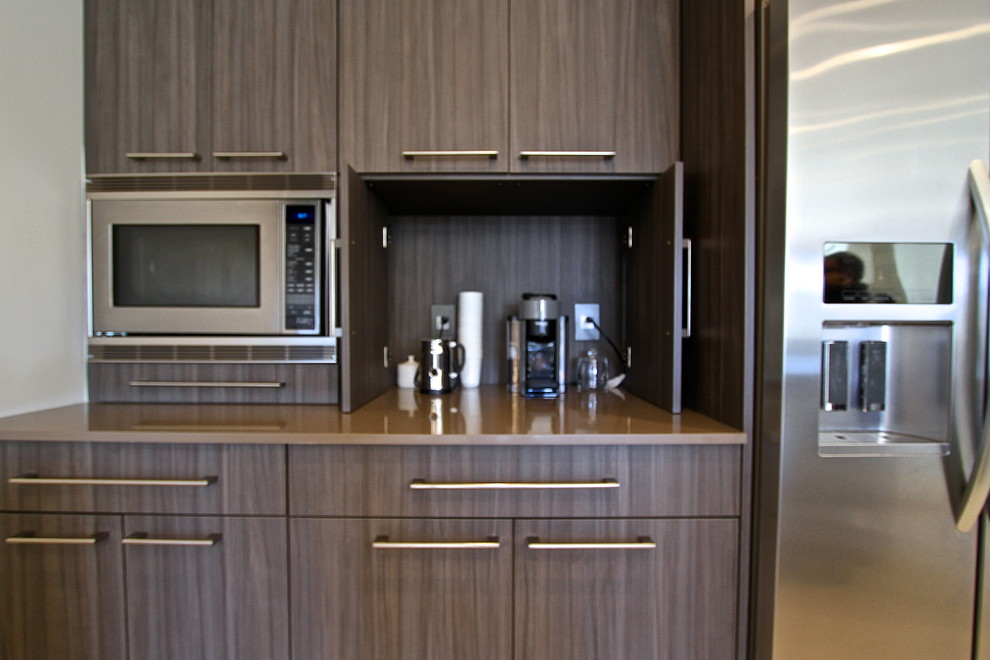 Inspiration for a mid-sized contemporary l-shaped ceramic tile eat-in kitchen remodel in Orange County with an undermount sink, flat-panel cabinets, dark wood cabinets, laminate countertops, blue backsplash, glass sheet backsplash, stainless steel appliances and an island