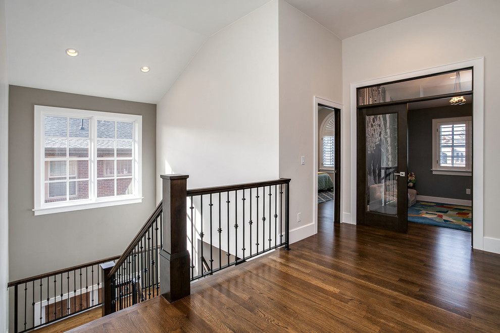 Mid-sized transitional wood u-shaped staircase in Denver with wood risers and metal railing.