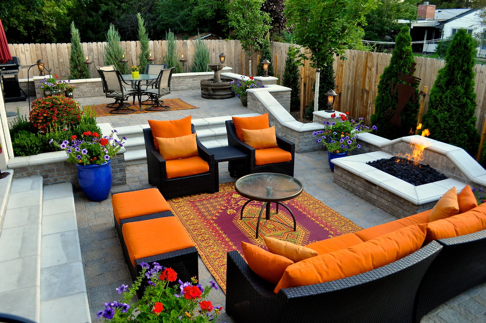 Inspiration for a mid-sized traditional backyard patio in Denver with a fire feature, concrete pavers and no cover.