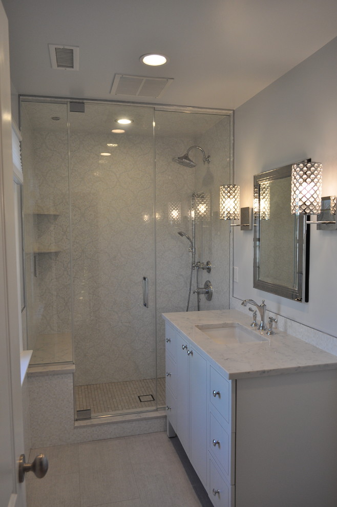 Photo of a mid-sized contemporary bathroom in New York with an undermount sink, furniture-like cabinets, white cabinets, engineered quartz benchtops, a two-piece toilet, multi-coloured tile, porcelain tile, grey walls, porcelain floors and with a sauna.