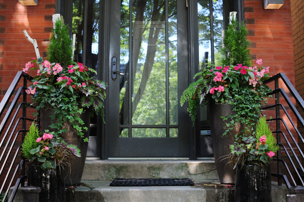 Inspiration for a mid-sized traditional partial sun front yard concrete paver landscaping in Chicago for summer.