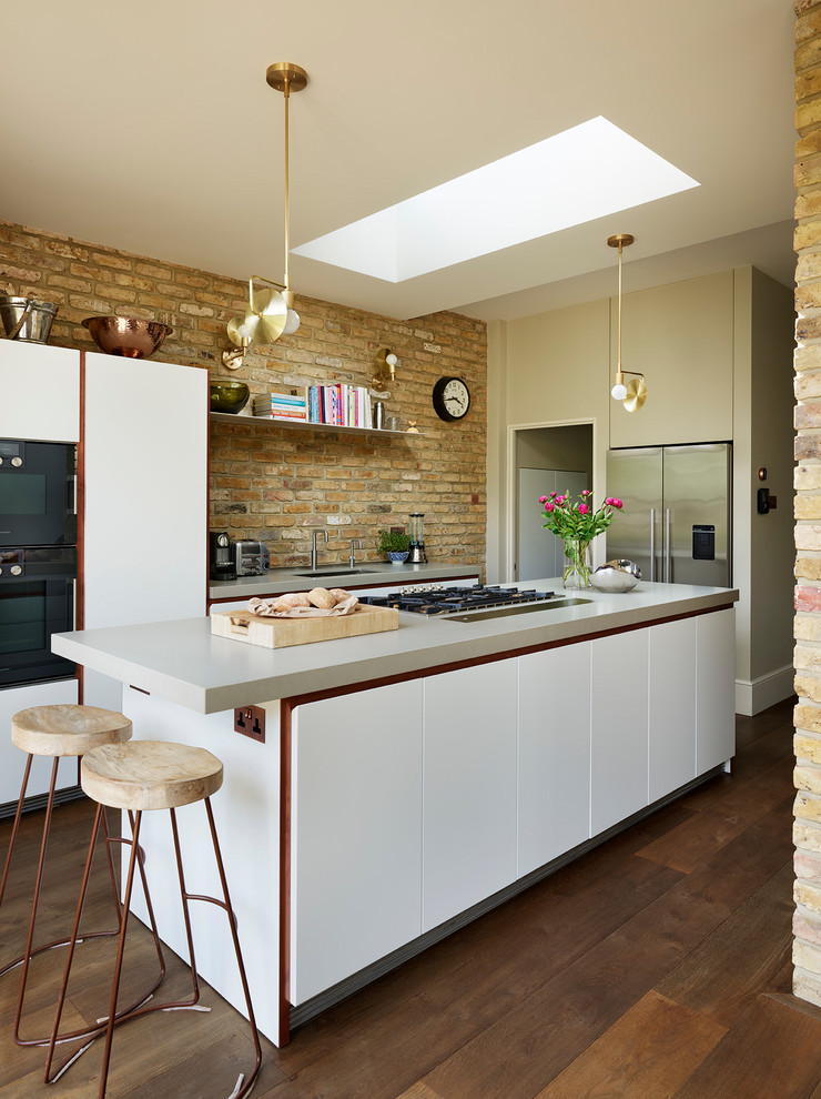 Mid-sized contemporary l-shaped kitchen in Other with an undermount sink, flat-panel cabinets, white cabinets, dark hardwood floors, with island, brown floor and brick splashback.