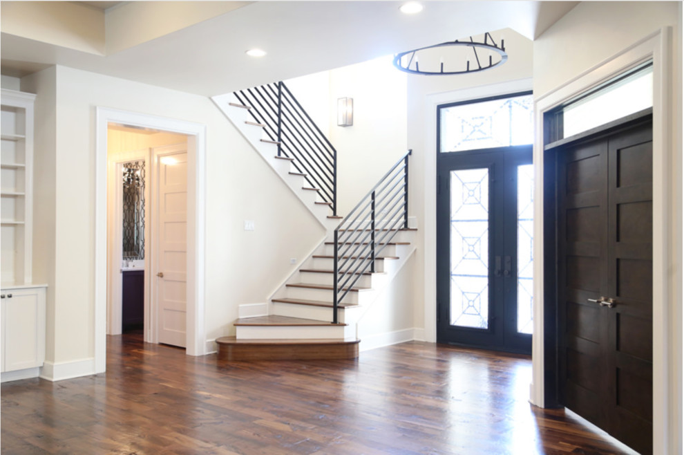 Inspiration for a mid-sized transitional dark wood floor foyer remodel with a black front door and white walls