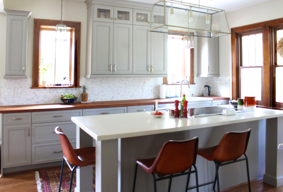 Eat-in kitchen - mid-sized transitional medium tone wood floor eat-in kitchen idea with a drop-in sink, gray cabinets, concrete countertops, white backsplash, stainless steel appliances and an island